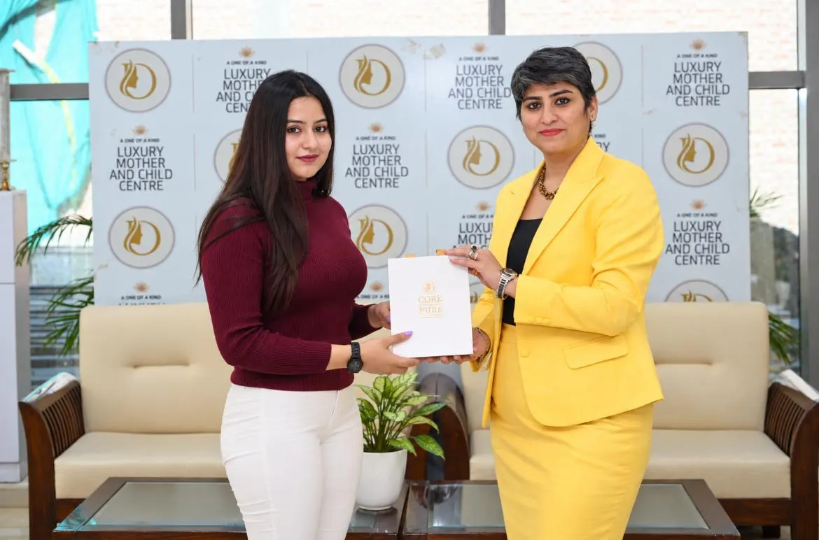 Dr. Raveena Yadav receiving a recognition certificate